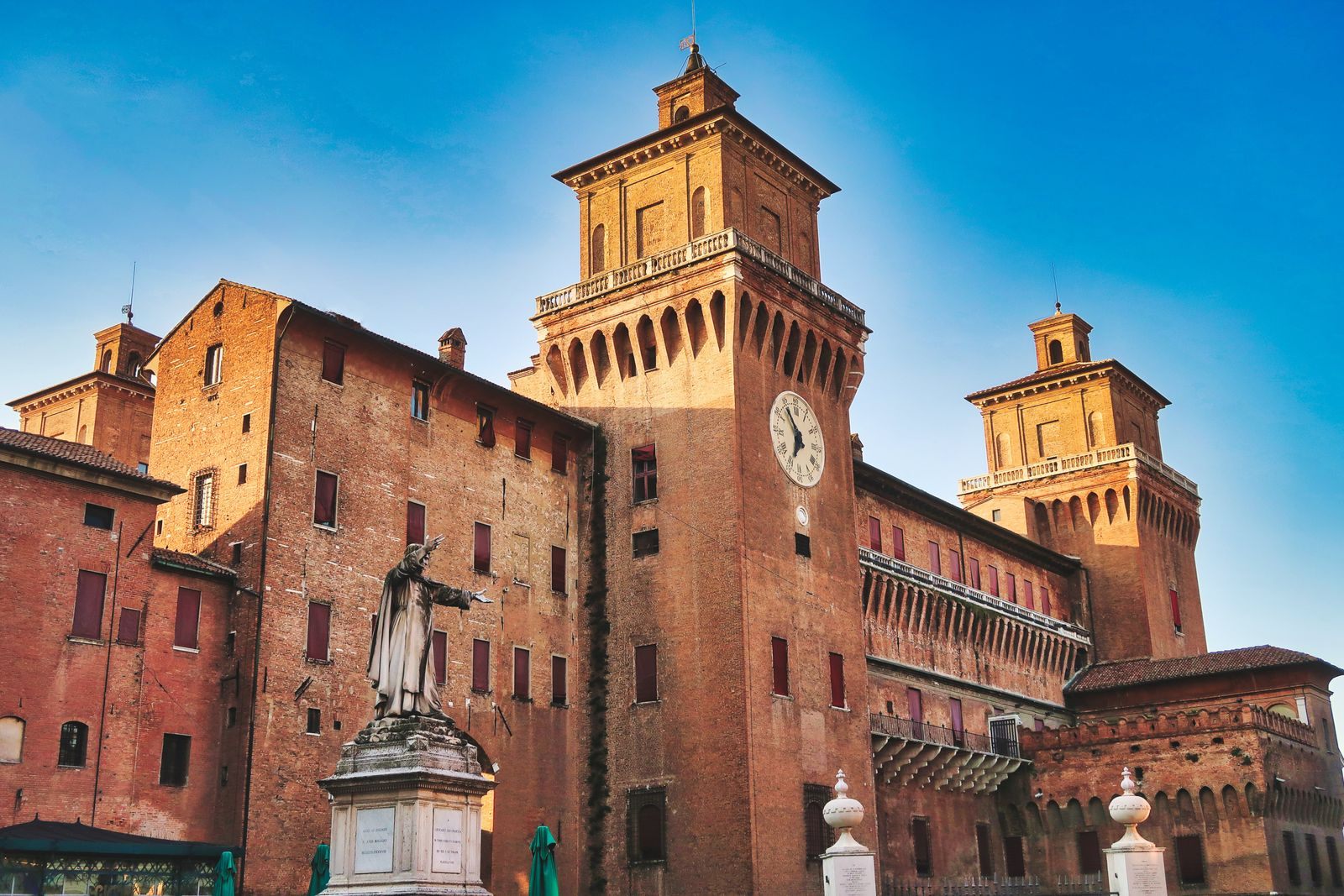 The moated Este Castle in Ferrara under a blue sky